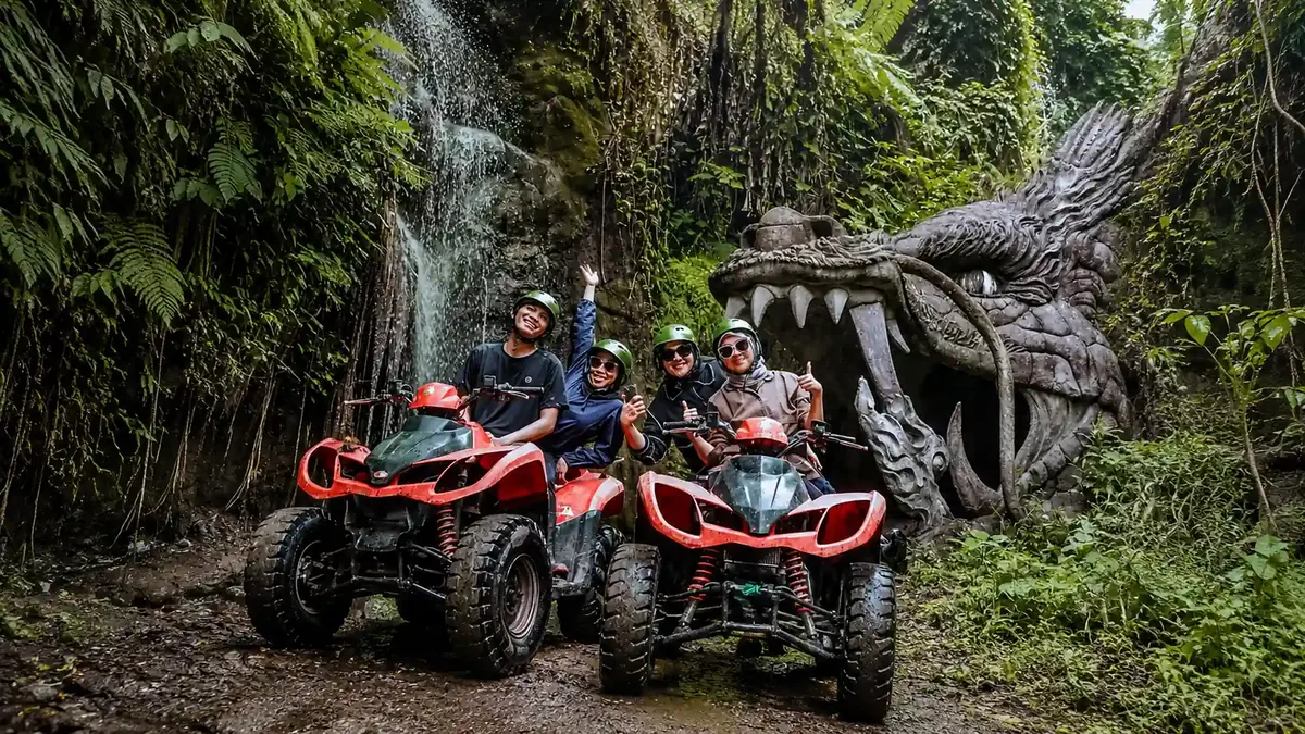 ATV riders at the Dragon Cave entrance and waterfall